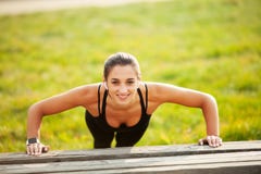 Fitness. Athletic woman standing in plank position outdoors at sunset. Concept of sport, recreation and motivation stock photo Fitness. Athletic woman standing in plank position outdoors at sunset. Concept of sport, recreation and motivation stock photo