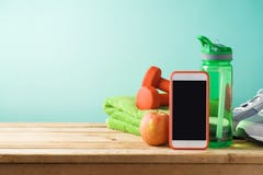 Fitness background with bottle of water, dumbbells and smart mob stock images Fitness background with bottle of water, dumbbells and smart mob stock images