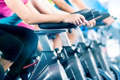 Fitness group Indoor bicycle cycling in gym