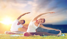 Couple making yoga exercises outdoors Stock Image Couple making yoga exercises outdoors Stock Image