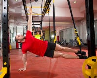 Fitness TRX training exercises at gym woman and man