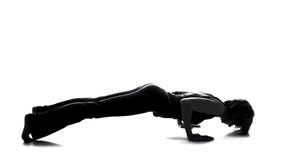 Fitness woman silhouette practicing yoga, plank exercise, home workout, health stock images Fitness woman silhouette practicing yoga, plank exercise, home workout, health stock images