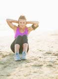 Fitness young woman doing abdominal crunch on beach stock images Fitness young woman doing abdominal crunch on beach stock images