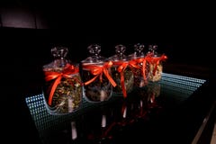 Glass jars with red bows in which tea is filled royalty free stock photo Glass jars with red bows in which tea is filled royalty free stock photo