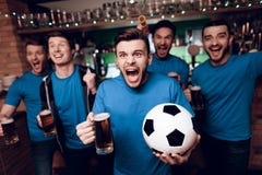 Five soccer fans drinking beer celebrating and cheering at sports bar. royalty free stock photos Five soccer fans drinking beer celebrating and cheering at sports bar. royalty free stock photos