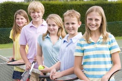Five young friends on tennis court