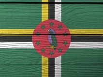 Flag of Dominica on wooden wall background. Grunge Dominica flag texture. royalty free stock image Flag of Dominica on wooden wall background. Grunge Dominica flag texture. royalty free stock image