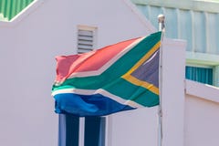 Flag of South Africa and traditional white building background royalty free stock photography Flag of South Africa and traditional white building background royalty free stock photography