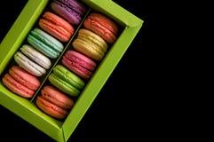 Flat lay. Close up. Sweet and colorful french macarons in a light green box, isolated on a black background. Copy space stock photography Flat lay. Close up. Sweet and colorful french macarons in a light green box, isolated on a black background. Copy space stock photography