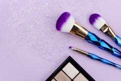 Flat lay colorful make up set with unicorn glitter on pastel purple background royalty free stock image Flat lay colorful make up set with unicorn glitter on pastel purple background royalty free stock image