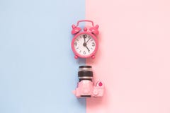 Dslr camera model and alarm clock isolated on pastel background minimalistic concept. Royalty Free Stock Photography Dslr camera model and alarm clock isolated on pastel background minimalistic concept. Royalty Free Stock Photography
