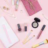 Flat Lay Home Office Desk. Female Workspace With Note Pad, Fashion Accessories And Make Up Products On Pink Background. Fashion Or Royalty Free Stock Image