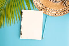 Flat lay photo blank notebook and coconut leaf and hat on blue background , top view and copy space for montage your product royalty free stock photo Flat lay photo blank notebook and coconut leaf and hat on blue background , top view and copy space for montage your product royalty free stock photo