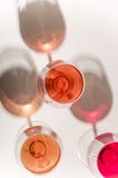 Glasses of white and pink wine with their shadows stock images Glasses of white and pink wine with their shadows stock images
