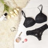 Flat Lay Stylish Black Lingerie Accessories And White Tulips On A White Background. Valentine`s Day 8 March Party Outfit Royalty Free Stock Image