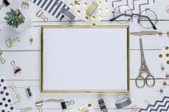 Flat lay, white wooden desk and golden frame. Gold stapler, stripe gold pattern, pencil. View top. Table up. Mock-up royalty free stock photo Flat lay, white wooden desk and golden frame. Gold stapler, stripe gold pattern, pencil. View top. Table up. Mock-up royalty free stock photo