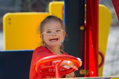 Flicka med Down Syndrome som har gyckel på lekplatsen royaltyfria bilder Flicka med Down Syndrome som har gyckel på lekplatsen royaltyfria bilder