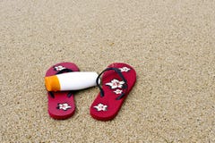 Flipflops And Sunscreen On The Beach Royalty Free Stock Photo Flipflops And Sunscreen On The Beach Royalty Free Stock Photo