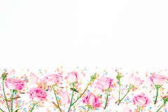 Floral Border Frame With Pink Flowers And Bright Candy Confetti On White Background. Flat Lay, Top View. Roses Flower Texture Stock Photo Floral Border Frame With Pink Flowers And Bright Candy Confetti On White Background. Flat Lay, Top View. Roses Flower Texture Stock Photo