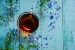Flower Tea And A Bouquet Of Forget-me-nots On A Wooden Background Royalty Free Stock Photos