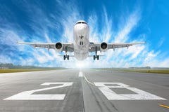 Flughafenrollbahn Nr. 28 und Flugzeug entfernen sich in zum Horizont und zu den malerischen Federwolkewolken im blauen Himmel Stockbild Flughafenrollbahn Nr. 28 und Flugzeug entfernen sich in zum Horizont und zu den malerischen Federwolkewolken im blauen Himmel Stockbild