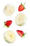Flying banana slices with strawberries on a white background royalty free stock photography Flying banana slices with strawberries on a white background royalty free stock photography