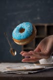Flying donut on a dark background. Flying blue donut on a dark background