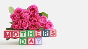 Focus on mothers day message with bunch of roses and gift