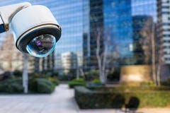 security CCTV camera or surveillance system with buildings on blurry background