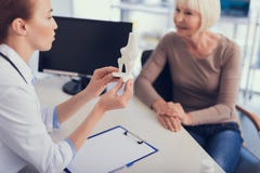 Female physician is demonstrating bone structure to lady royalty free stock image Female physician is demonstrating bone structure to lady royalty free stock image
