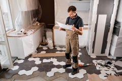 Focused diligent worker inspecting room and planning repairs work. repair of the dining room in the house, kitchen stock photography Focused diligent worker inspecting room and planning repairs work. repair of the dining room in the house, kitchen stock photography