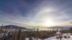 Foggy Morning in the Winter Mountains Forest on the Background of Dramatic Cloudy Sky. Timelapse. 4K stock video footage Foggy Morning in the Winter Mountains Forest on the Background of Dramatic Cloudy Sky. Timelapse. 4K stock video footage