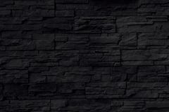 Fond noir de mur en pierre images stock Fond noir de mur en pierre images stock