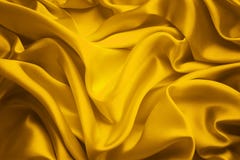 Fondo de la tela de seda, ondas amarillas del paño del satén, materia textil que agita imágenes de archivo libres de regalías Fondo de la tela de seda, ondas amarillas del paño del satén, materia textil que agita imágenes de archivo libres de regalías