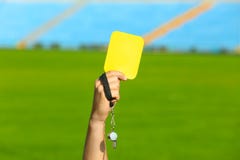 Football referee holding yellow card and whistle at stadium royalty free stock photos Football referee holding yellow card and whistle at stadium royalty free stock photos