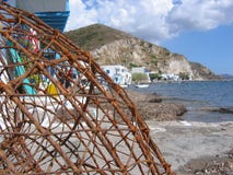 Foreground of a net from fishermen with after all a white village. Island of Milos. Greece. royalty free stock photography Foreground of a net from fishermen with after all a white village. Island of Milos. Greece. royalty free stock photography