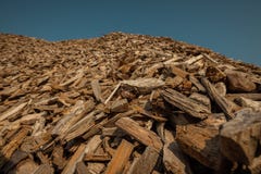 Forest residues mulched as wood chips used for heating. Pile of wood chip particles for biomass boiler, view from below