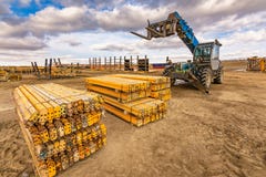 Forklift on a construction site, preparing to raise construction parts royalty free stock photography Forklift on a construction site, preparing to raise construction parts royalty free stock photography