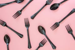 Forks and spoons on a pink background. Minimal concept royalty free stock photo Forks and spoons on a pink background. Minimal concept royalty free stock photo