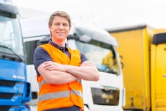Forwarder or driver in front of trucks in depot