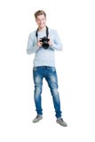 Fotógrafo novo que guarda uma câmera da foto do dslr imagens de stock royalty free Fotógrafo novo que guarda uma câmera da foto do dslr imagens de stock royalty free