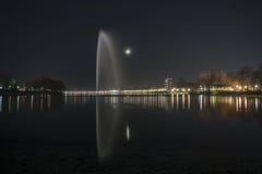 Fountain on the lake ada with the moon in the background and lighting stock photography Fountain on the lake ada with the moon in the background and lighting stock photography