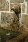 Fountain made of stone with a small water spout royalty free stock image Fountain made of stone with a small water spout royalty free stock image