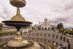 Fountain and plaza of the `Basilica Nuestra Señora de los Ãngeles` in front of a cloudy sky stock image Fountain and plaza of the `Basilica Nuestra Señora de los Ãngeles` in front of a cloudy sky stock image