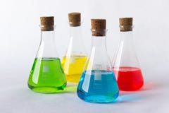 Four laboratory flasks with cork plugs and colorful liquids royalty free stock photo Four laboratory flasks with cork plugs and colorful liquids royalty free stock photo