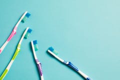 Four multi-colored toothbrushes on a blue background royalty free stock photo Four multi-colored toothbrushes on a blue background royalty free stock photo