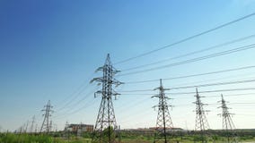 Four power energy lines of high-voltage transmission pylons with industrial background and clear blue sky. Illustration