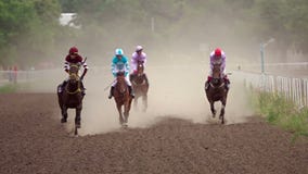 Four Riders On Horse Races. Slow Motion Royalty Free Stock Photography