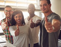 Four small business owners with thumbs up stock photo Four small business owners with thumbs up stock photo