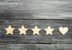 Four stars and a heart on a dark background. Selection of the user and clients. Universal recognition and admiration. Rating of a stock photography Four stars and a heart on a dark background. Selection of the user and clients. Universal recognition and admiration. Rating of a stock photography
